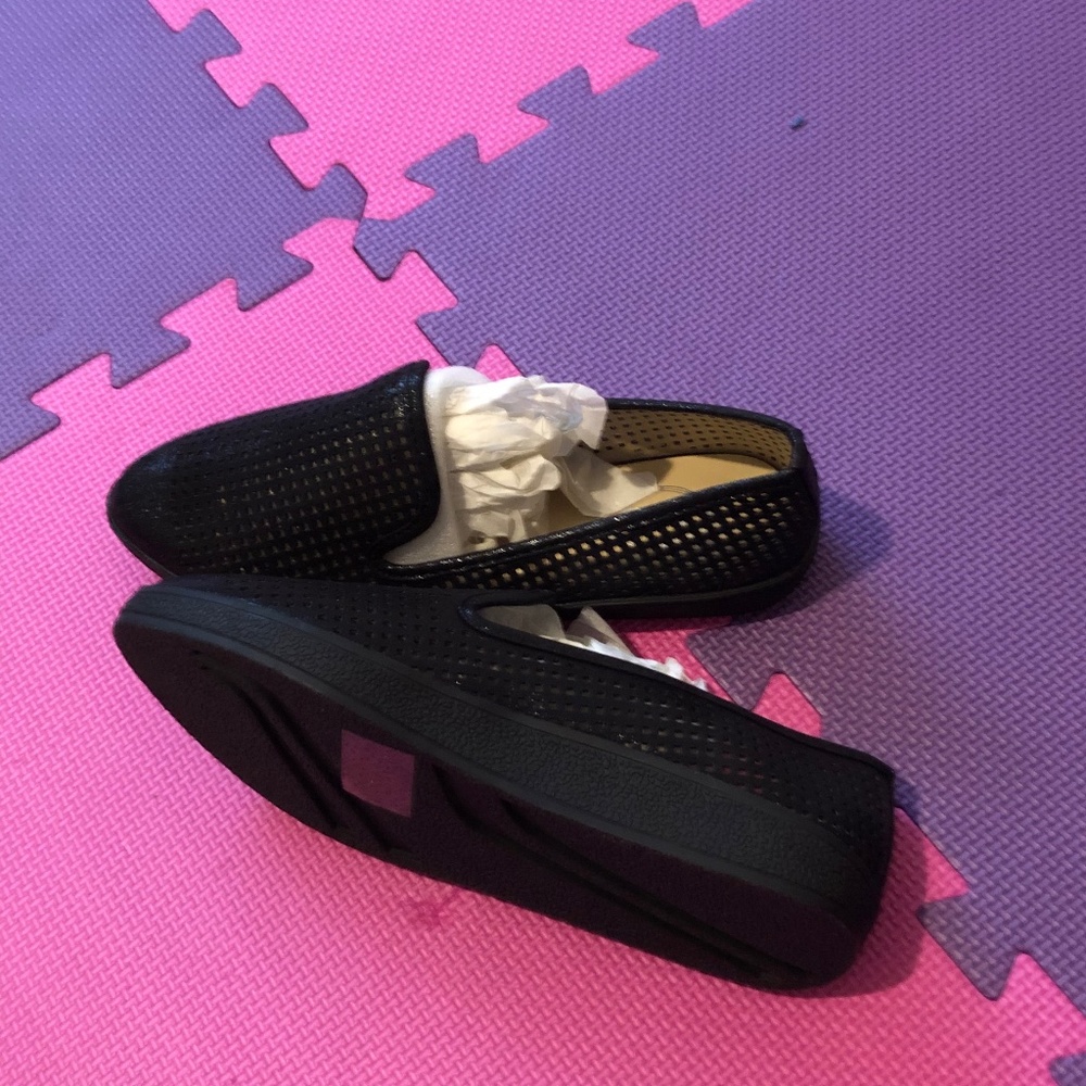 Black, flat woman’s shoe, size 8.